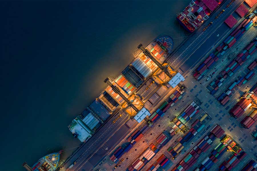 container port during night with a container ship docking