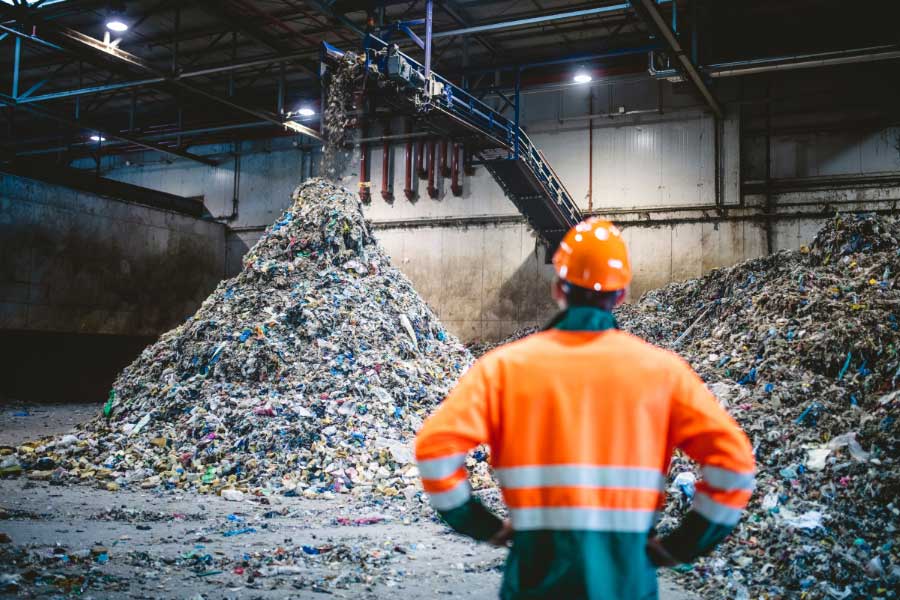 man in organge vest at a waste facility